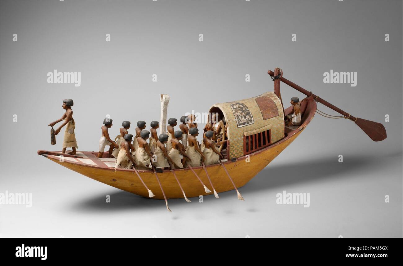 Travelling Boat being Rowed. Dimensions: l. 128 cm (50 3/8 in), with rudder 175 cm (68 7/8 in) x w. with oars 30.5 cm (12 in) x h. 37 cm (14 9/16 in). Dynasty: Dynasty 12. Reign: reign of Amenemhat I, early. Date: ca. 1981-1975 B.C..  This model of a riverboat was found with twenty three other models of boats, gardens, and workshops in a hidden chamber at the side of the passage leading into the rock cut tomb of the royal chief steward Meketre, who began his career under King Nebhepetre Mentuhotep II of Dynasty 11 and continued to serve successive kings into the early years of Dynasty 12.  Mek Stock Photo
