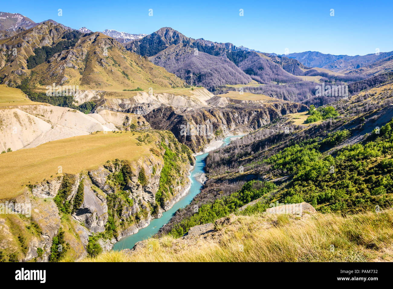 Once famed for goldmining, the Shotover River winds it's way through Skippers Canyon, near Queenstown, New Zealand, on a beautiful sunny spring day Stock Photo