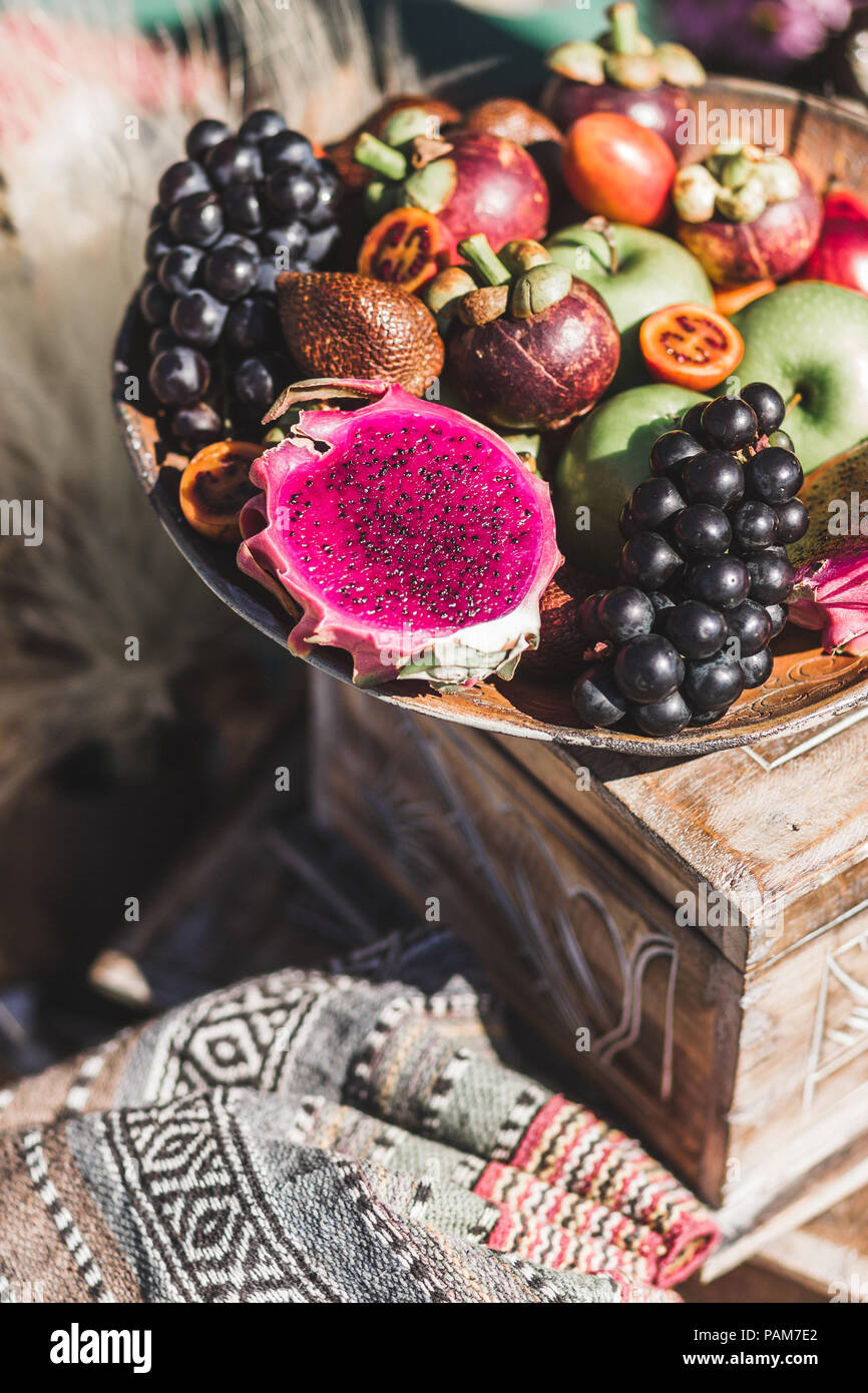 Fruit plate with apple, passion fruit, grape, mangosteen, dragonfruit on wooden plate Stock Photo