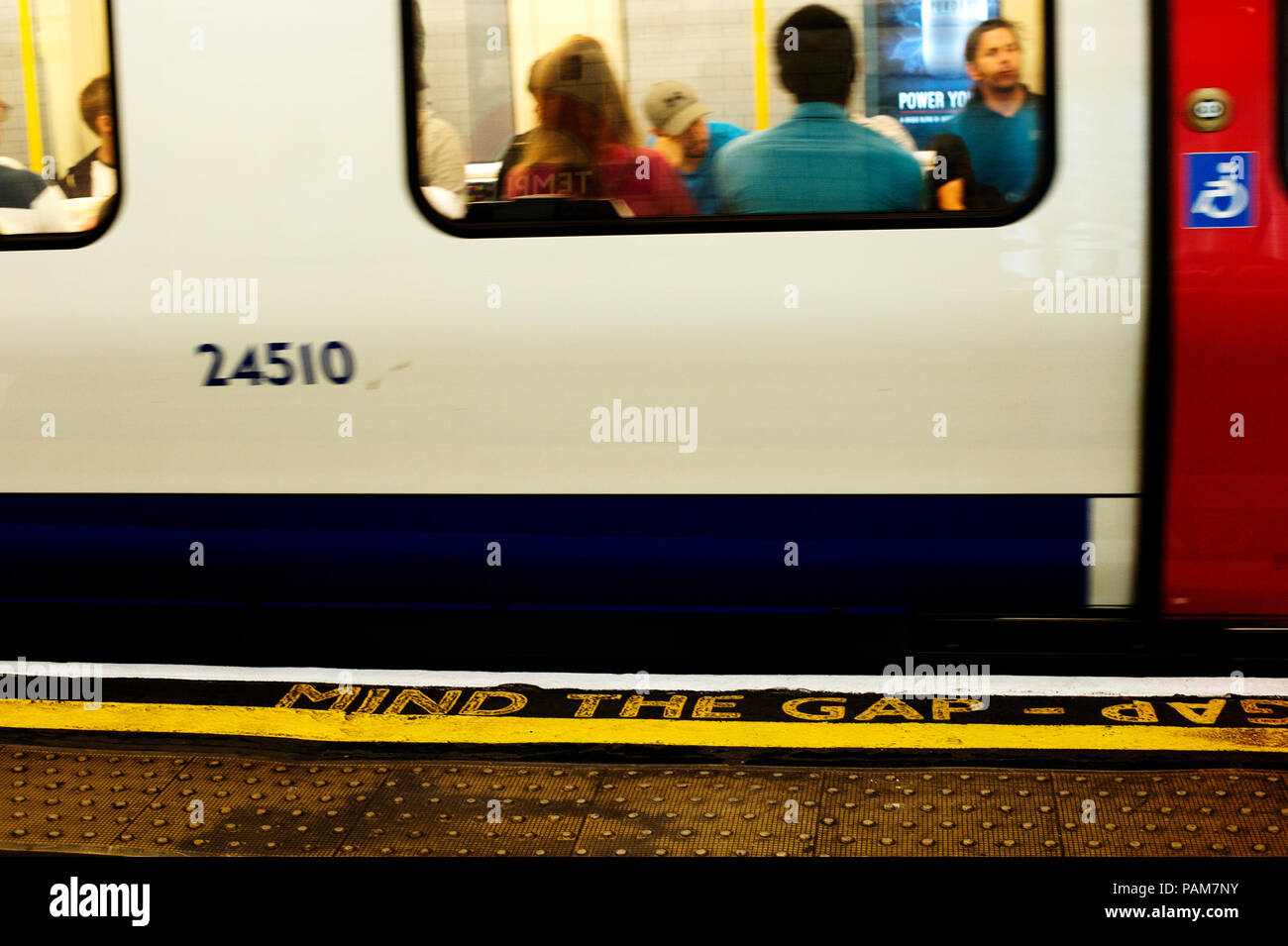London underground. Mind the gap sign and tube train. Stock Photo