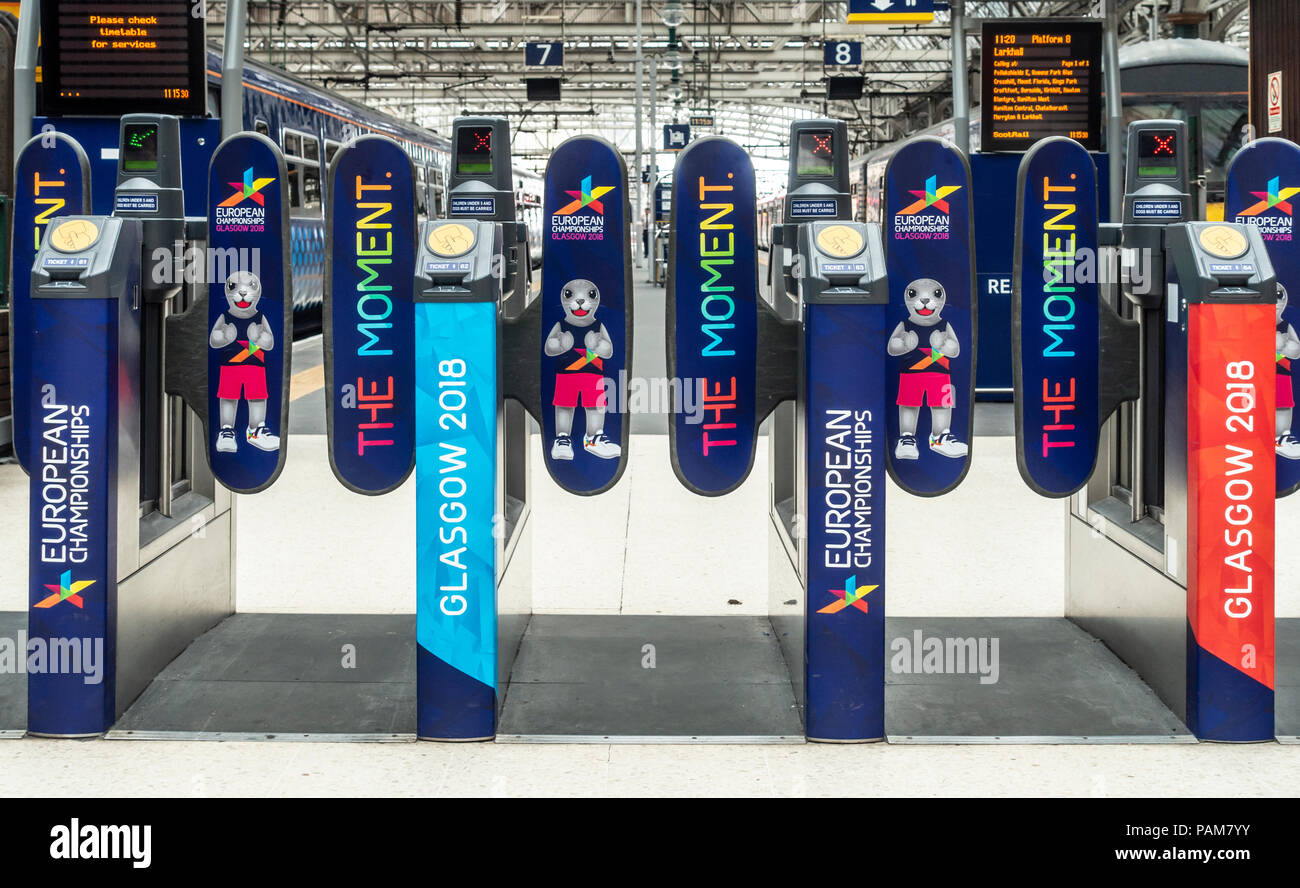 Barriers at Glasgow Central Station covered wtih branding reflecting Glasgow 2018, the European Championships, a multi-sports event hosted in Glasgow Stock Photo