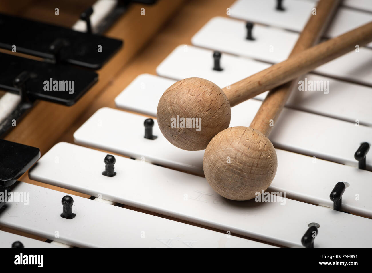 Details of a Glockenspiel with black and white keys and wooden mallets