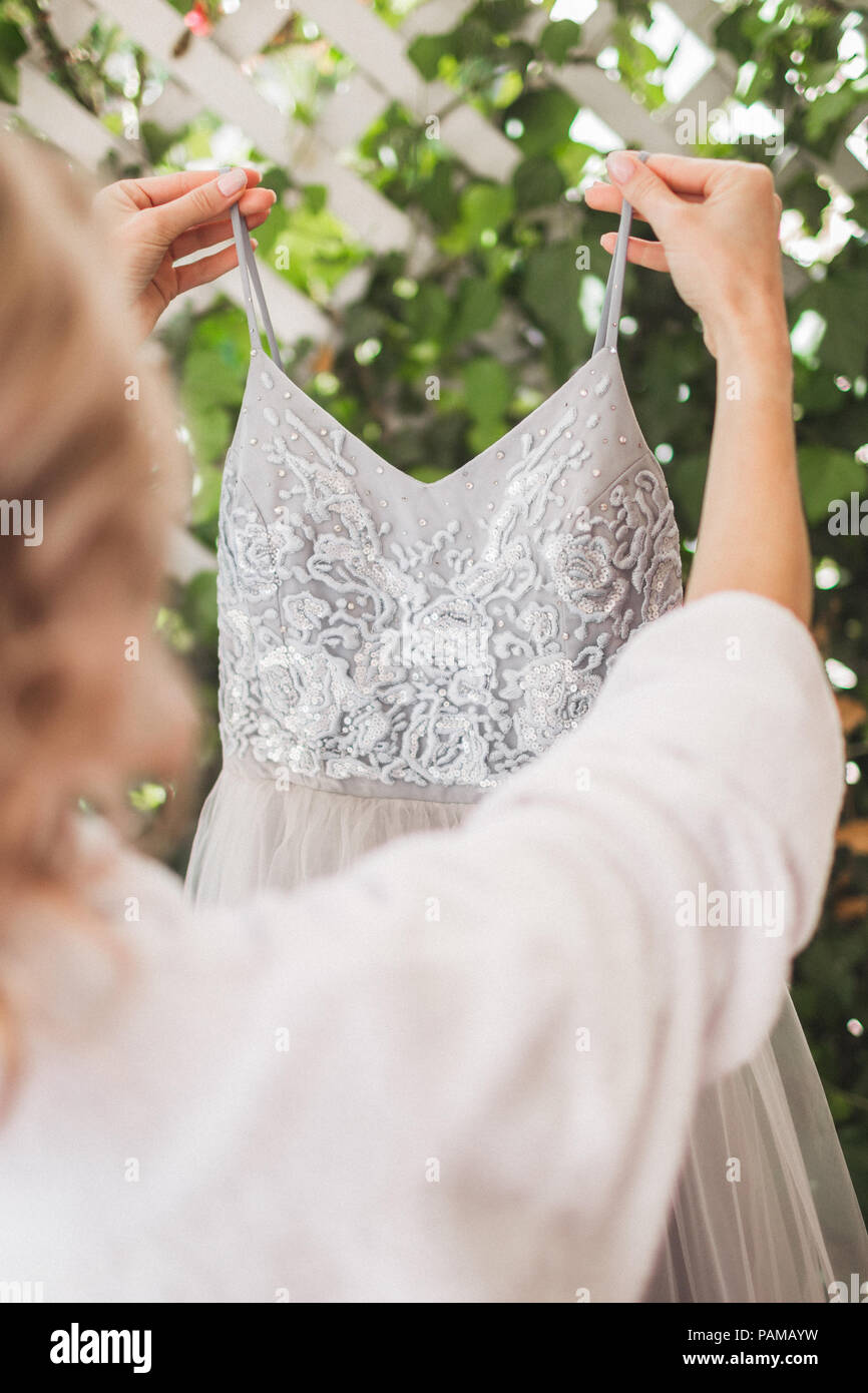 Bride wearing gray fashionable silk wedding dress embroidered with lace