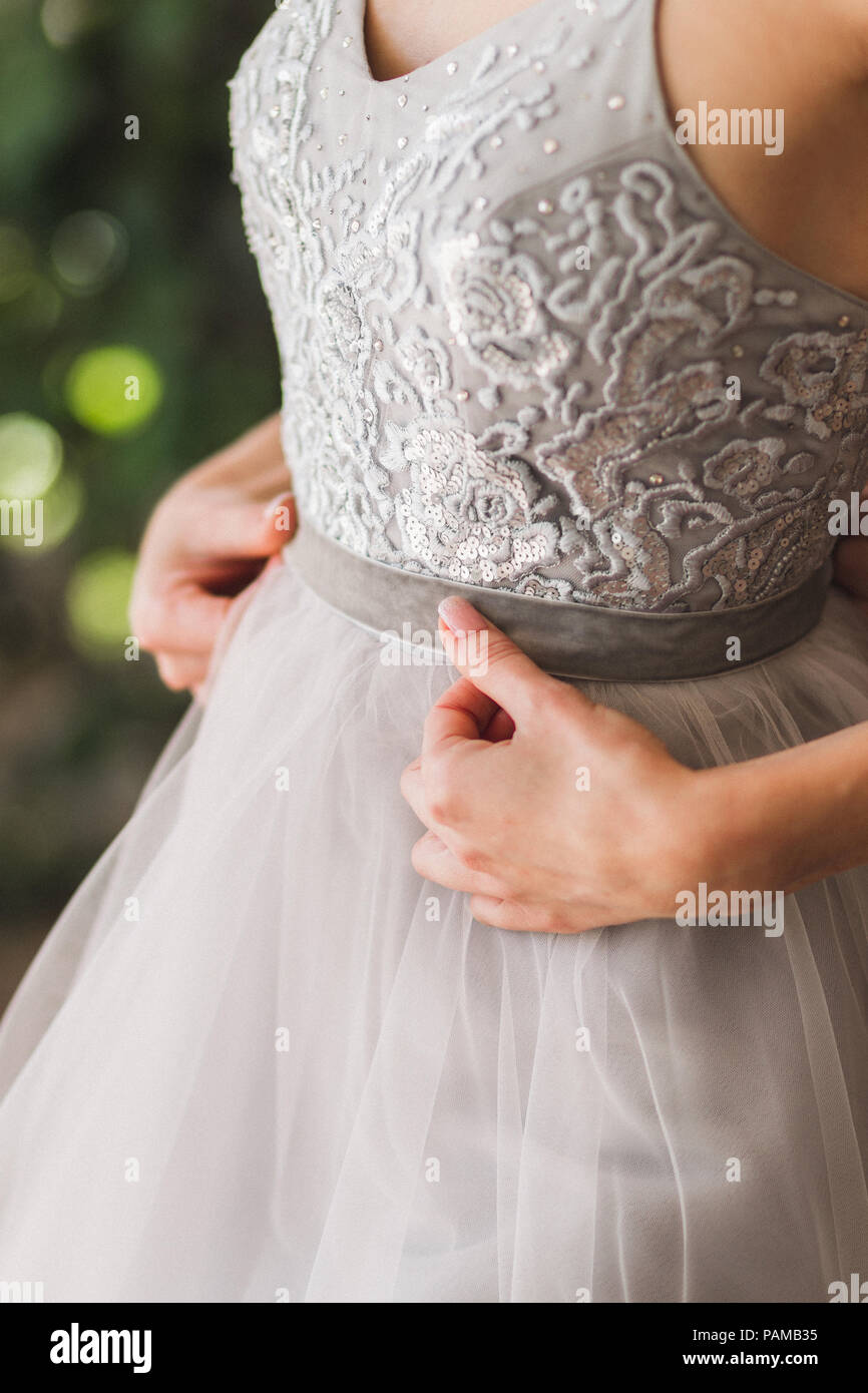 Bride wearing gray fashionable silk wedding dress embroidered with lace