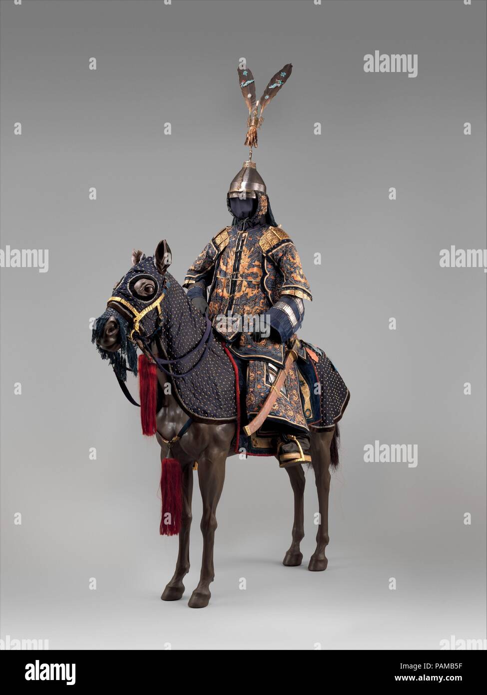 Ceremonial Armors for Man (Dingjia) and Horse. Culture: Chinese. Date: 18th century.  The man's armor, known as dingjia (armor with nails), is a very elaborate example of the military costume worn at the imperial court by high-ranking officials in the eighteenth and nineteenth centuries. It consists of a jacket with sleeves and an ankle-length skirt constructed of narrow overlapping plates riveted inside the fabric layers with the securing rivet heads visible on the outside. Some of these plates, of brightly polished steel, are exposed on the arms and skirt. Although not intended for use in ba Stock Photo