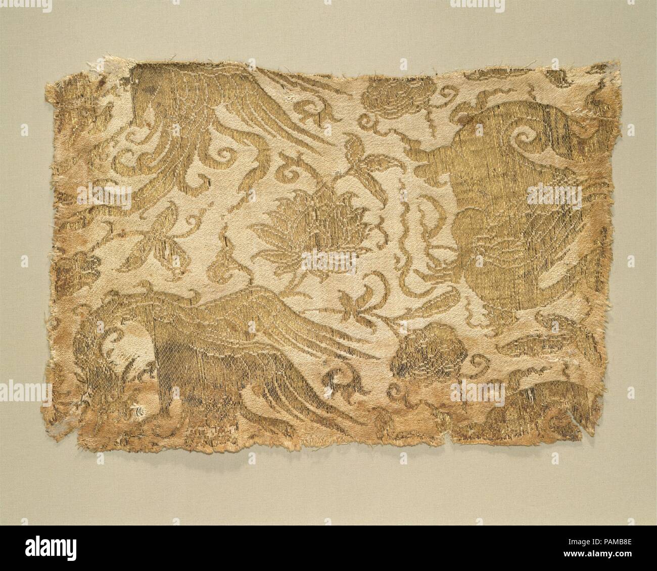 Textile with Phoenix, Winged Animal and Flowers. Culture: Central Asia. Dimensions: 9 5/16 x 6 1/2 in. (23.7 x 16.5 cm). Date: 13th-early 14th century.  Few silks better represent the imagination and vitality of Central Asian textiles of the Mongol period than this piece, with its angry birds and strange, incomplete winged beasts against an airy floral background. Other Central Asian textiles of this type survive in European church treasuries and show dynamic interactions among the various imaginary creatures of their patterns. Such designs had a strong effect on fourteenth- to fifteenth-centu Stock Photo
