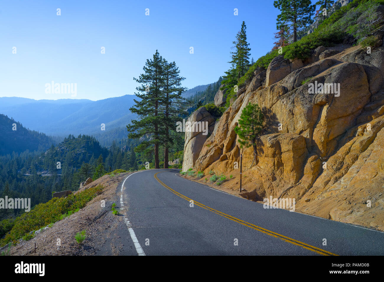 A high elevation descent and curve in the road - Highway 108, California Stock Photo