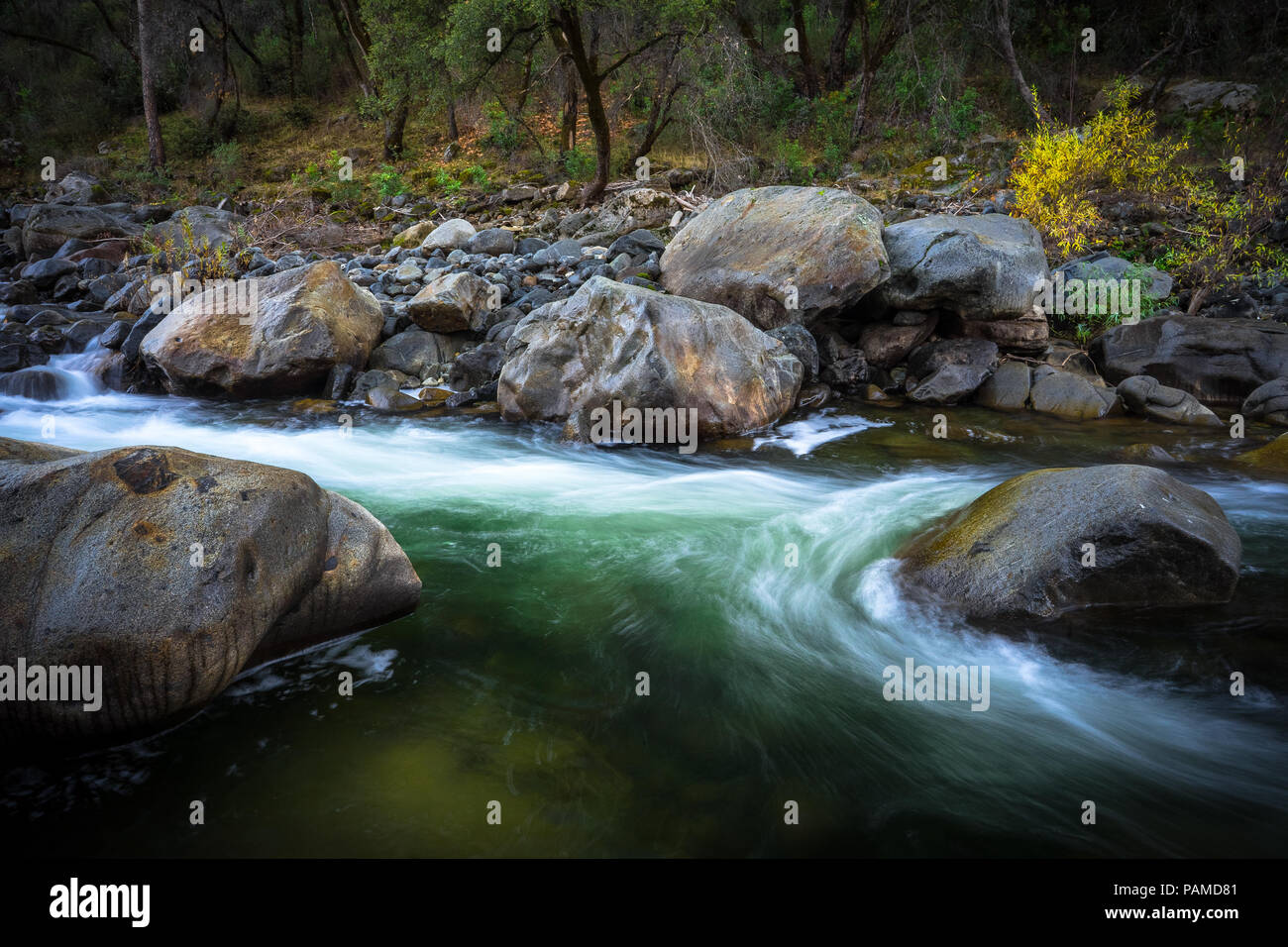 Beautiful green pool with swirling rapids - Tuolumne River in Groveland, California Stock Photo