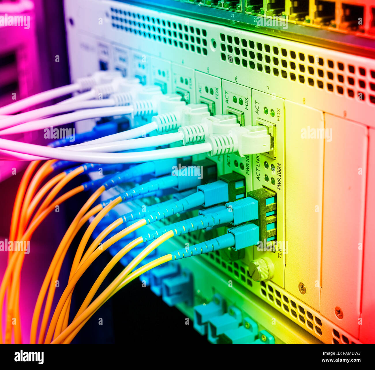 Fiber Optic cables connected to optic ports and UTP, Network cables connected to ethernet ports. Stock Photo
