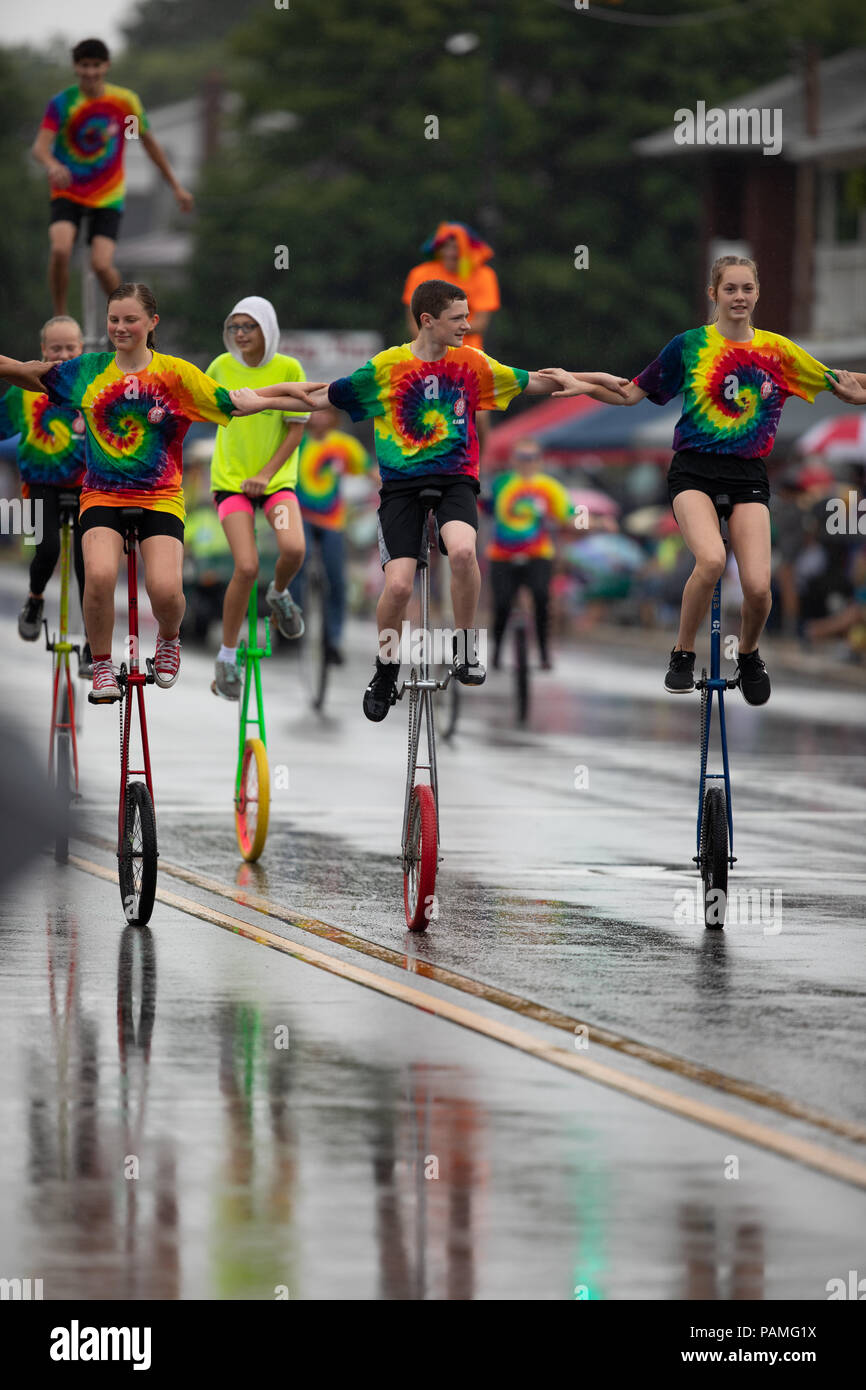 Peru, Indiana, USA July 21, 2018 Men and women riding unicycles under