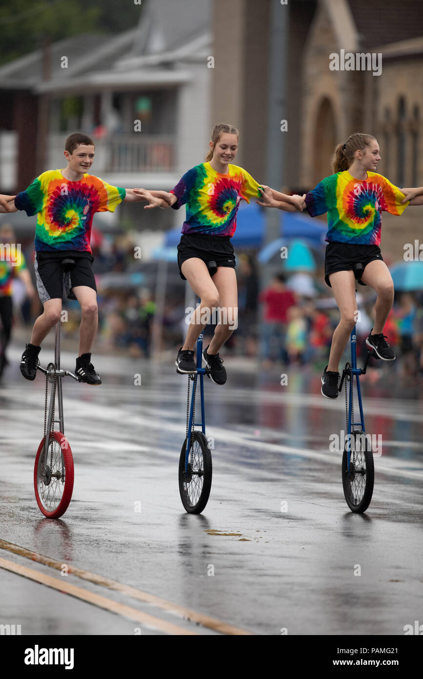 Peru, Indiana, USA July 21, 2018 Men and women riding unicycles under