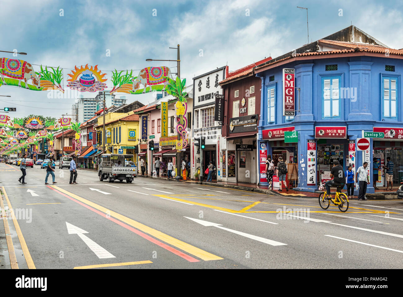 Singapore, January 12, 2018: Traffic on the street in the part of Singapore called Little India. Colorful old colonial houses and decoration over the  Stock Photo