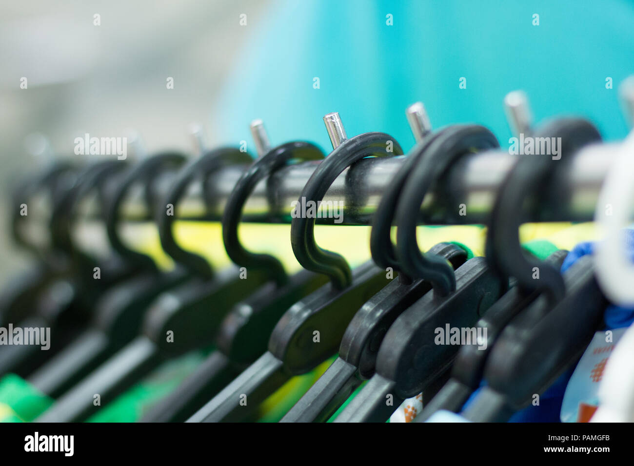 Plastic hangers with clothes in the store Stock Photo Alamy