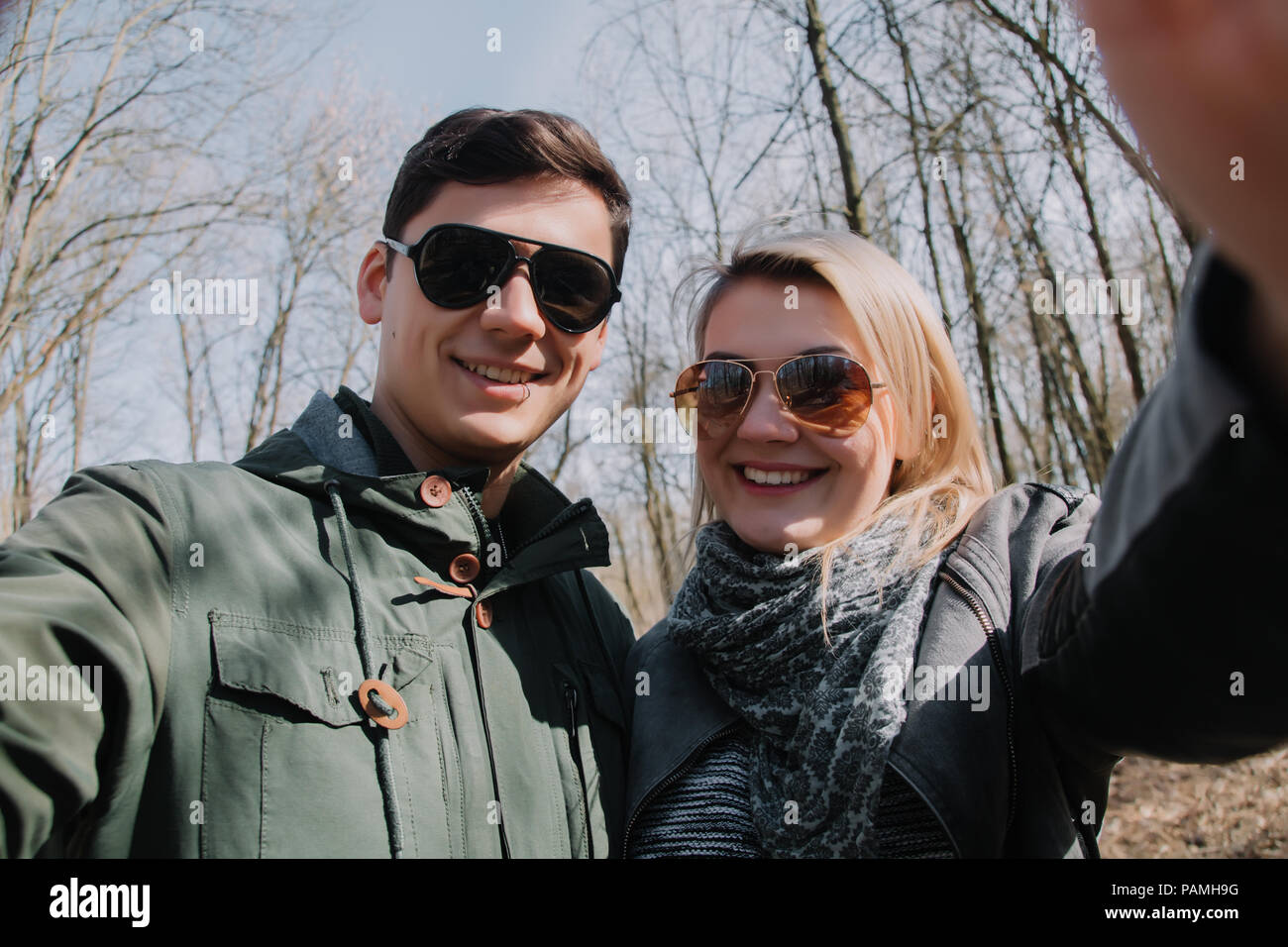 Cheerful loving each other couple kisses. Walk in the park and hug