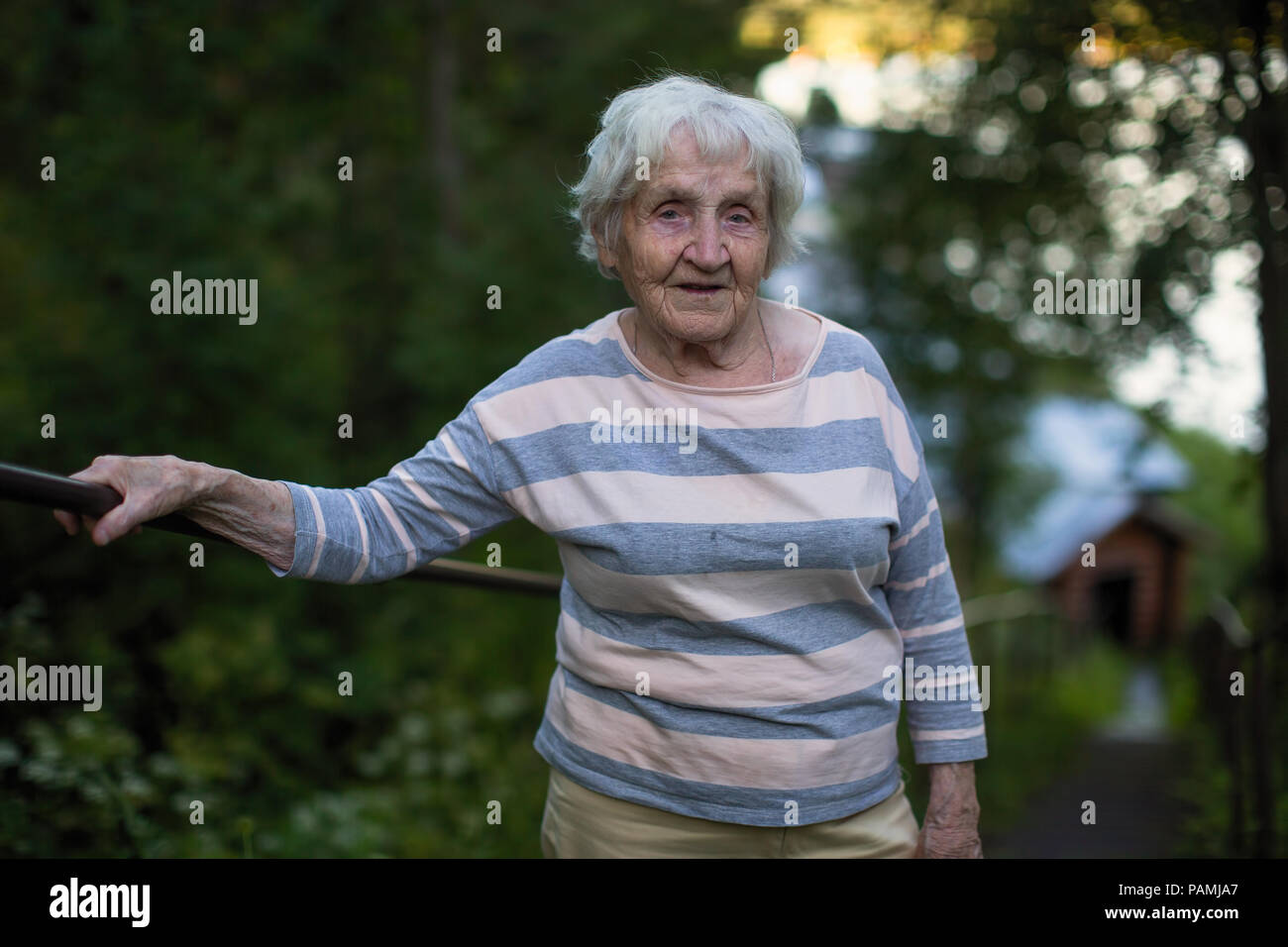 Portrait of elderly woman walks in the Park Stock Photo - Alamy