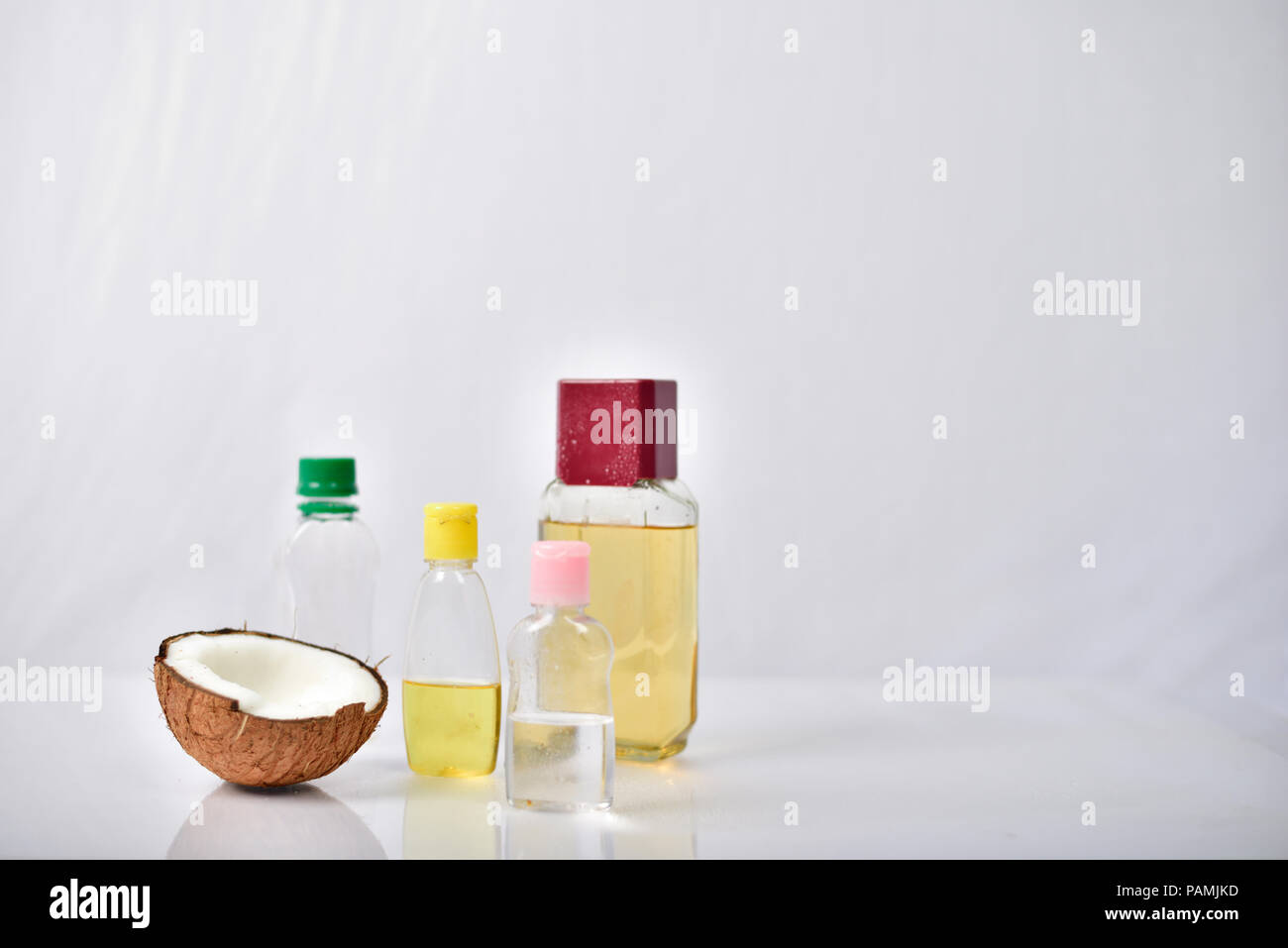 Coconut oil with coconut on white background Stock Photo Alamy