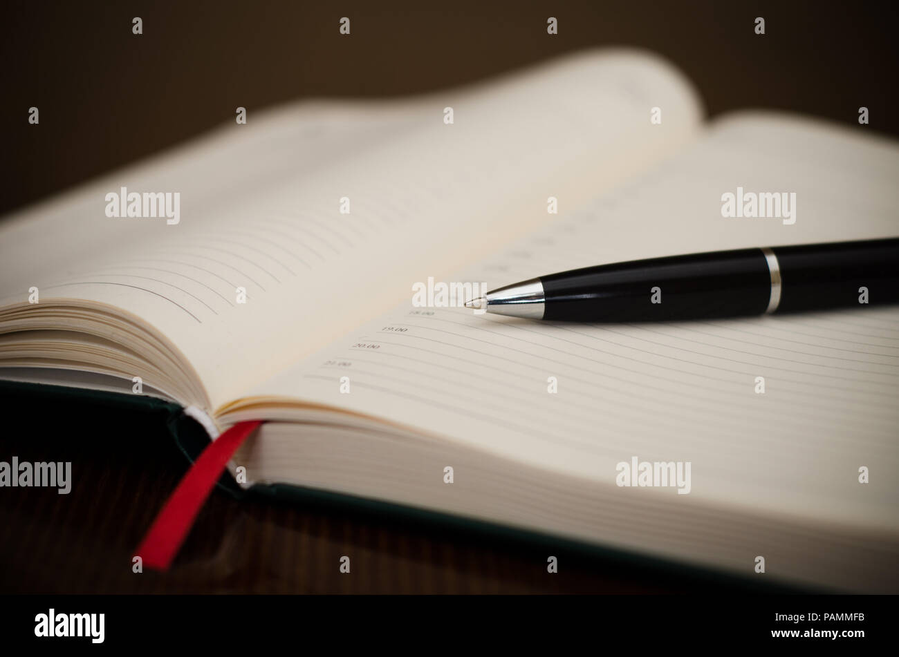 Schedule with a pen and a red ribbon at work with a bussines look Stock Photo