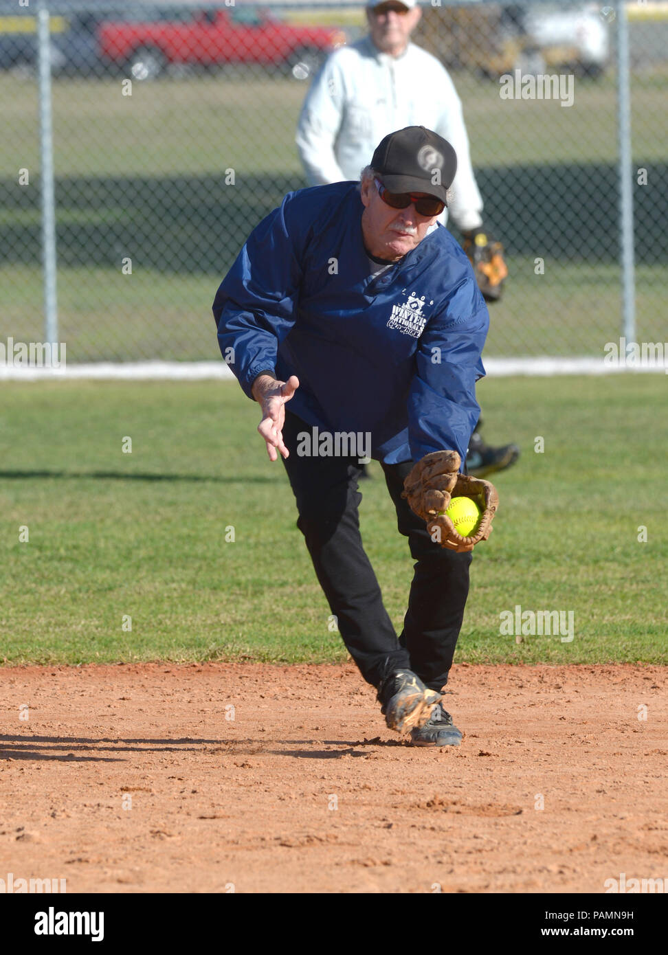 An older infielder makes a play during senior sofball play in Venice, Florida. Stock Photo