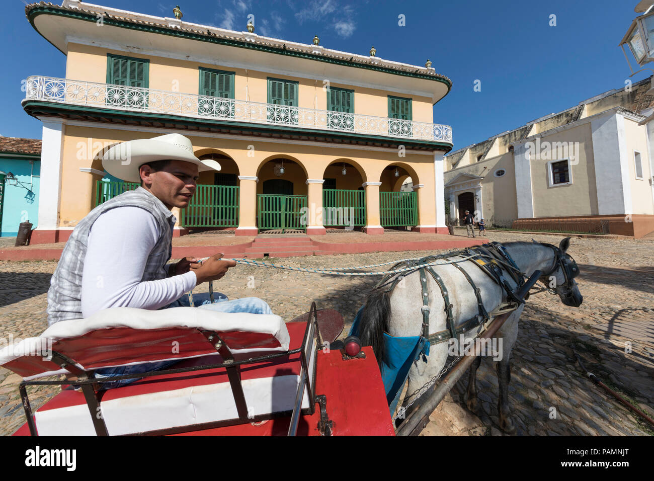 A horse-drawn cart known locally as a coche in Plaza Mayor, in the UNESCO World Heritage town of Trinidad, Cuba. Stock Photo