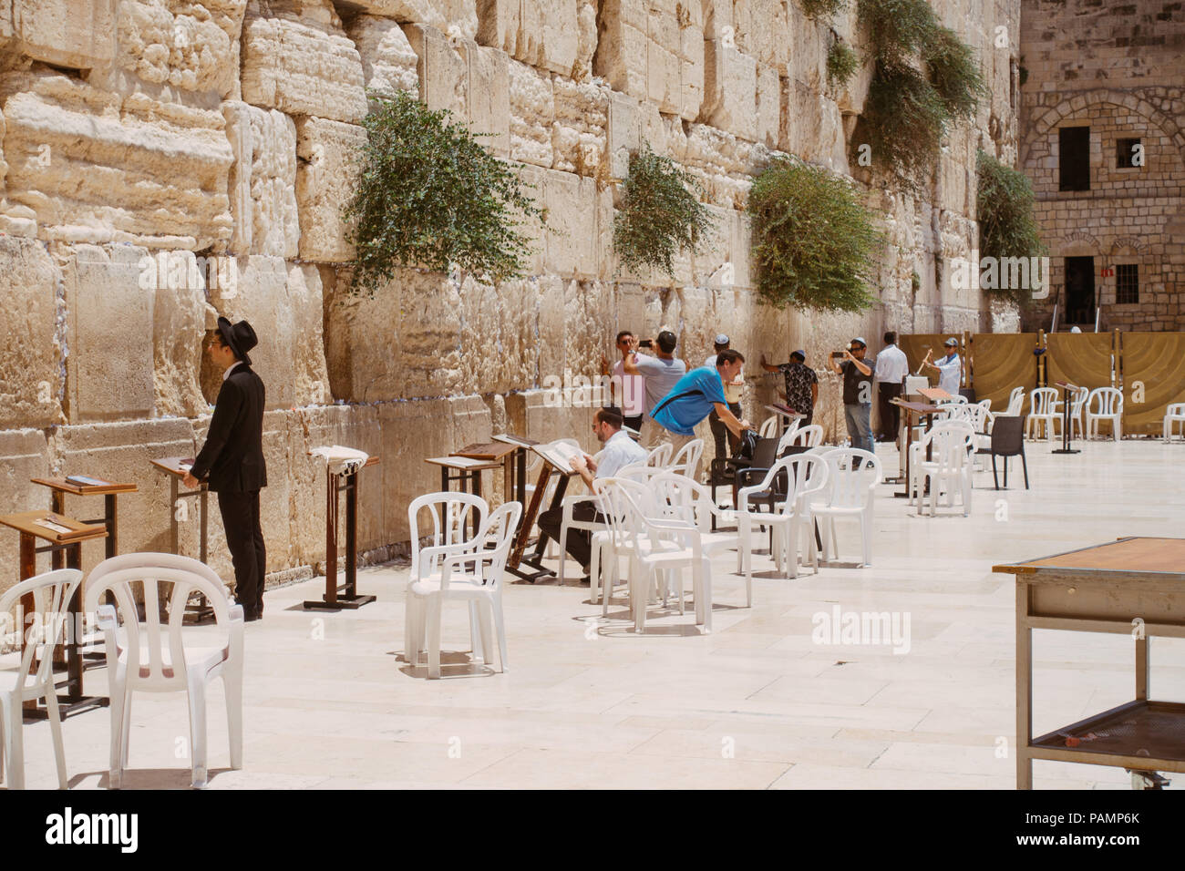 Worshippers say their prayers at the Western Wall on a sunny afternoon, Jerusalem Stock Photo