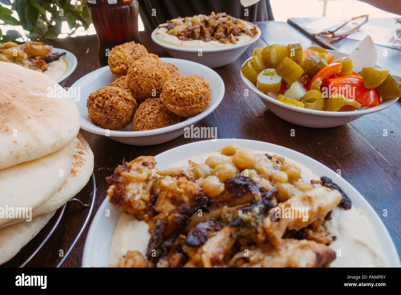 bowls of fresh falafel and hummus sit on a table in Jerusalem, Israel Stock Photo