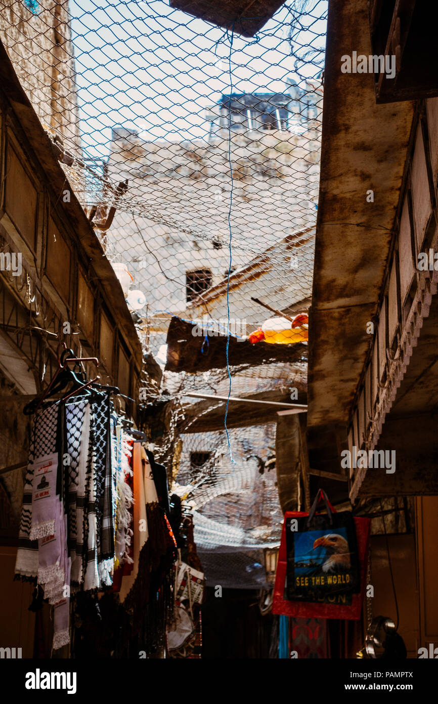 The main street in the Old Market, Hebron. The net catches rocks, household and human waste thrown down by Israeli settlers living in apartments above Stock Photo