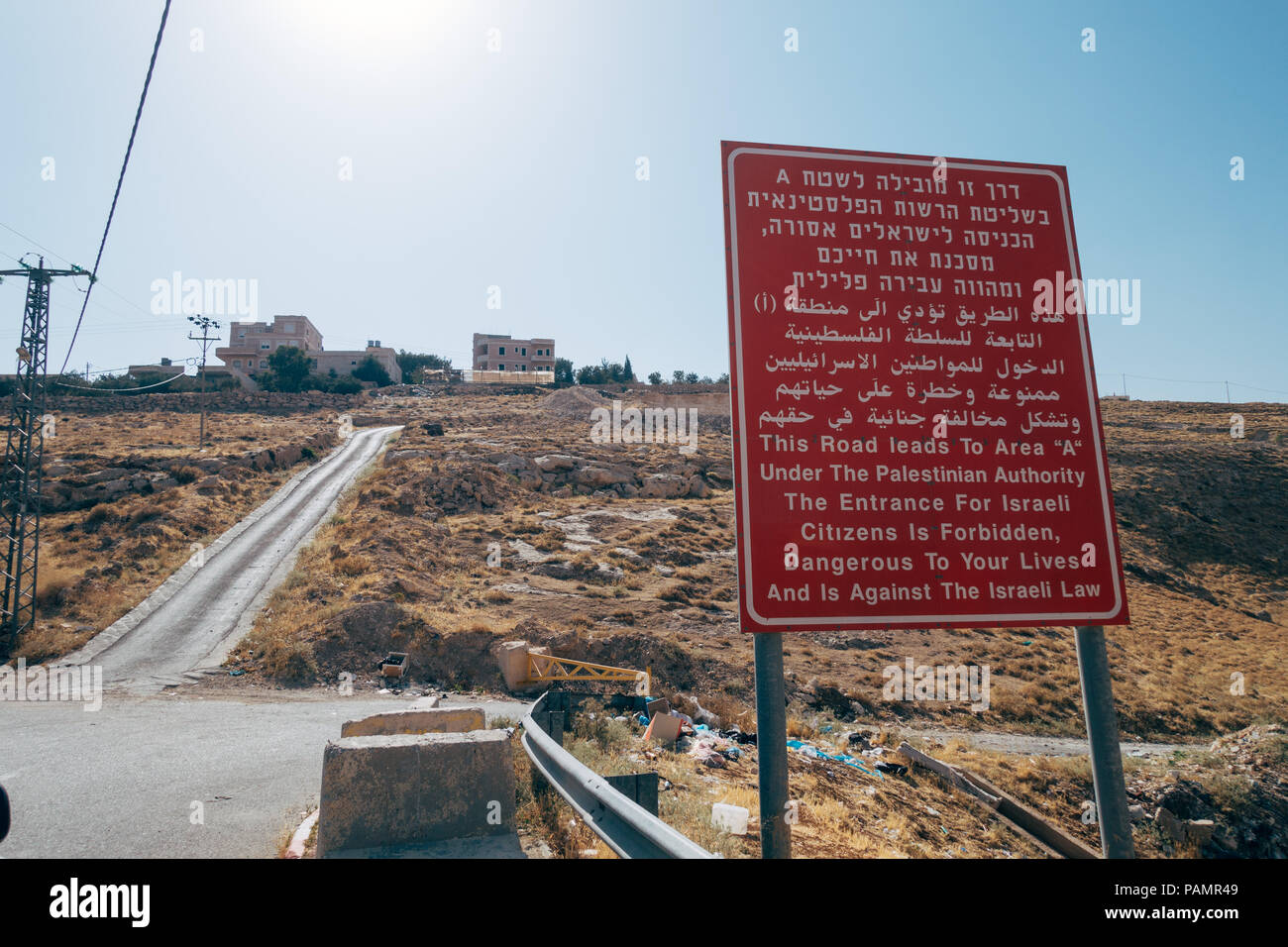 a sign near one of the checkpoints in Hebron, Israel, forbidding Israelis to travel into Palestinian Area A, written in Hebrew, Arabic and English. Stock Photo