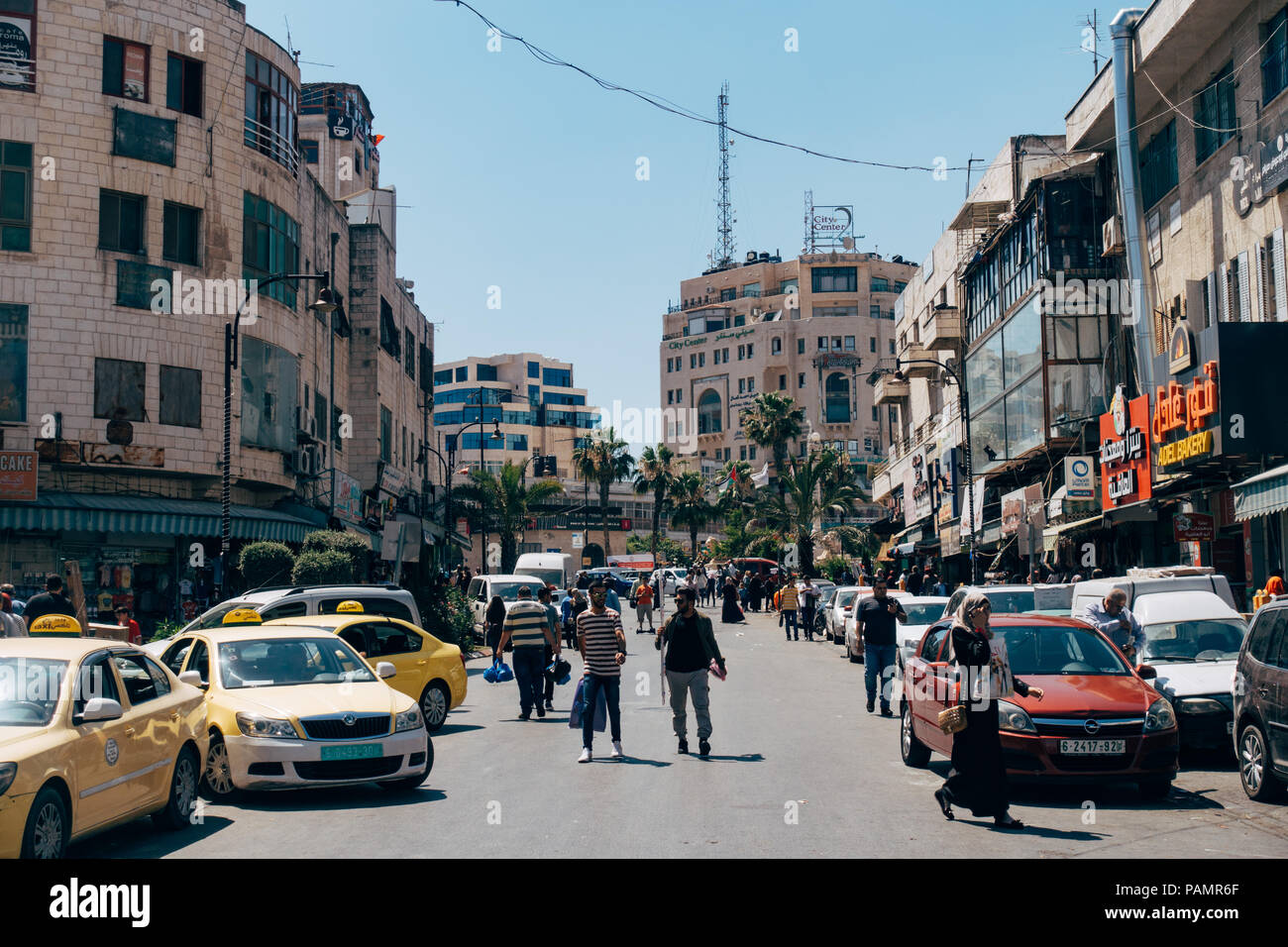 busy streets packed with taxis and people during an afternoon in Ramallah, Palestine's capital city and administrative centre Stock Photo