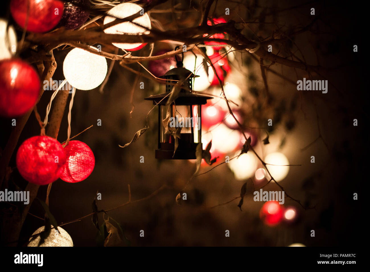 Candle holding lantern along with red and white spherical lanterns