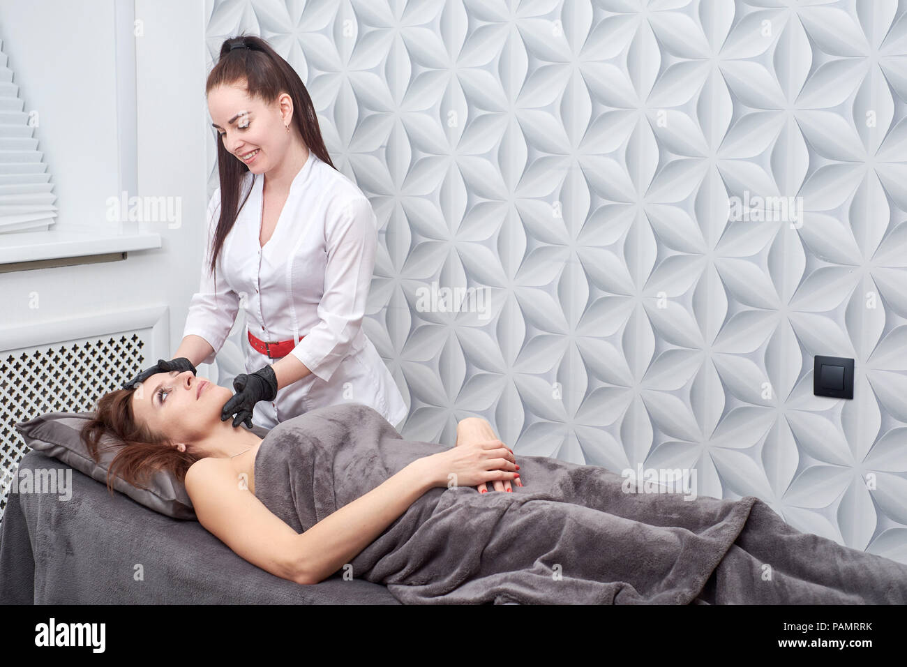 Massage and facial peels at the salon using cosmetics Stock Photo