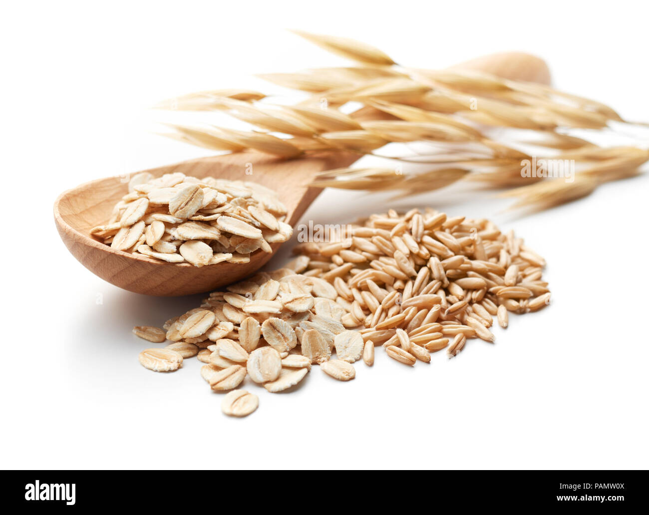 scoop and pile of oatmeal with its unprocessed grains and plant Stock Photo