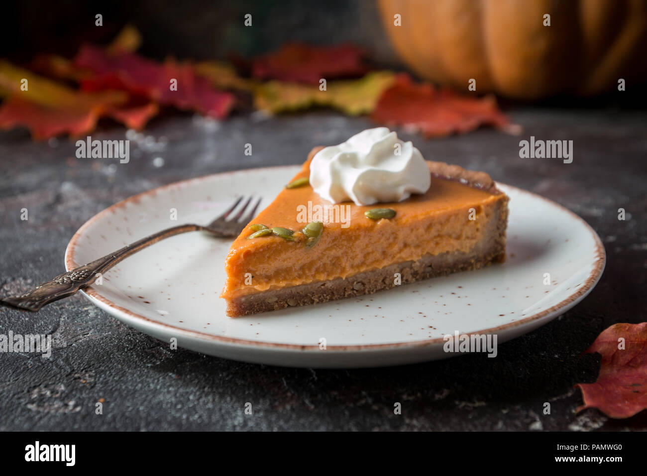 Slice of Festive Homemade Pumpkin Pie with Whipped Cream Stock Photo