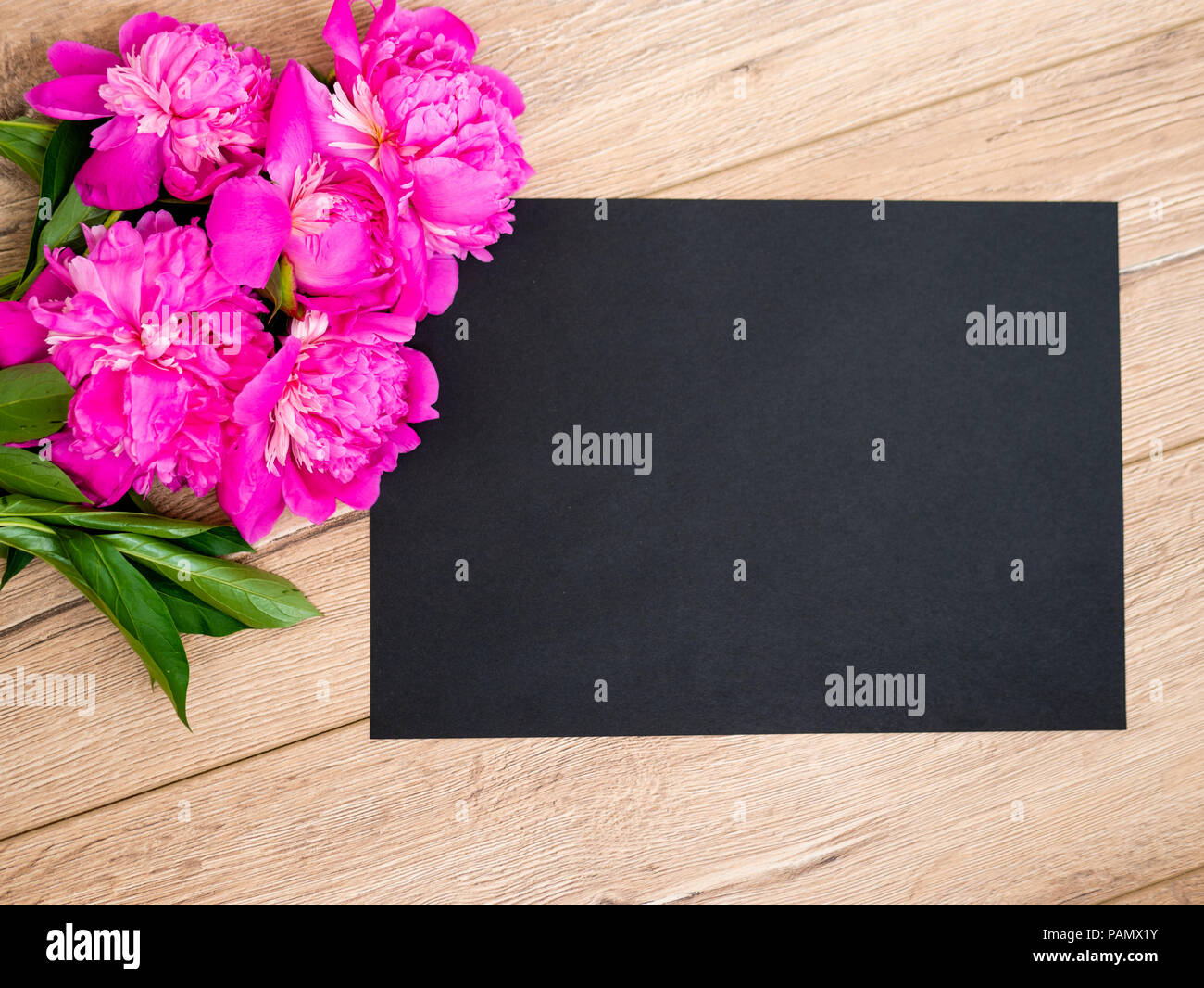 Pink floral assorted pink flower on wooden background with black paper free space, copy space for tekst Stock Photo