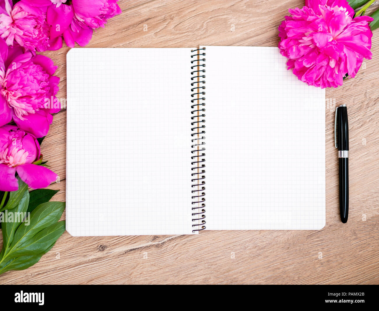 Pink floral assorted pink flower on wooden background with notepad free space, copy space for tekst Stock Photo