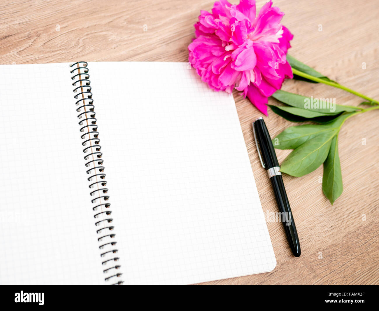 Pink floral assorted pink flower on wooden background with notepad free space, copy space for tekst Stock Photo