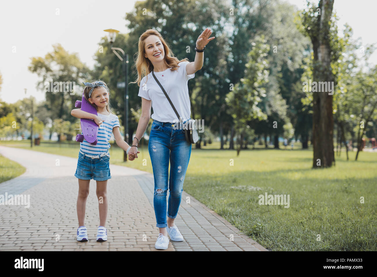 Beautiful mother taking her birthday girl to the park Stock Photo