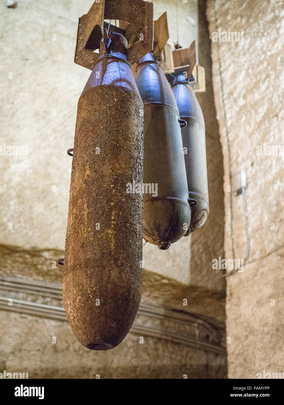 A guide shows tourists WW2 bomb cases inside Napoli Sotterranea, a