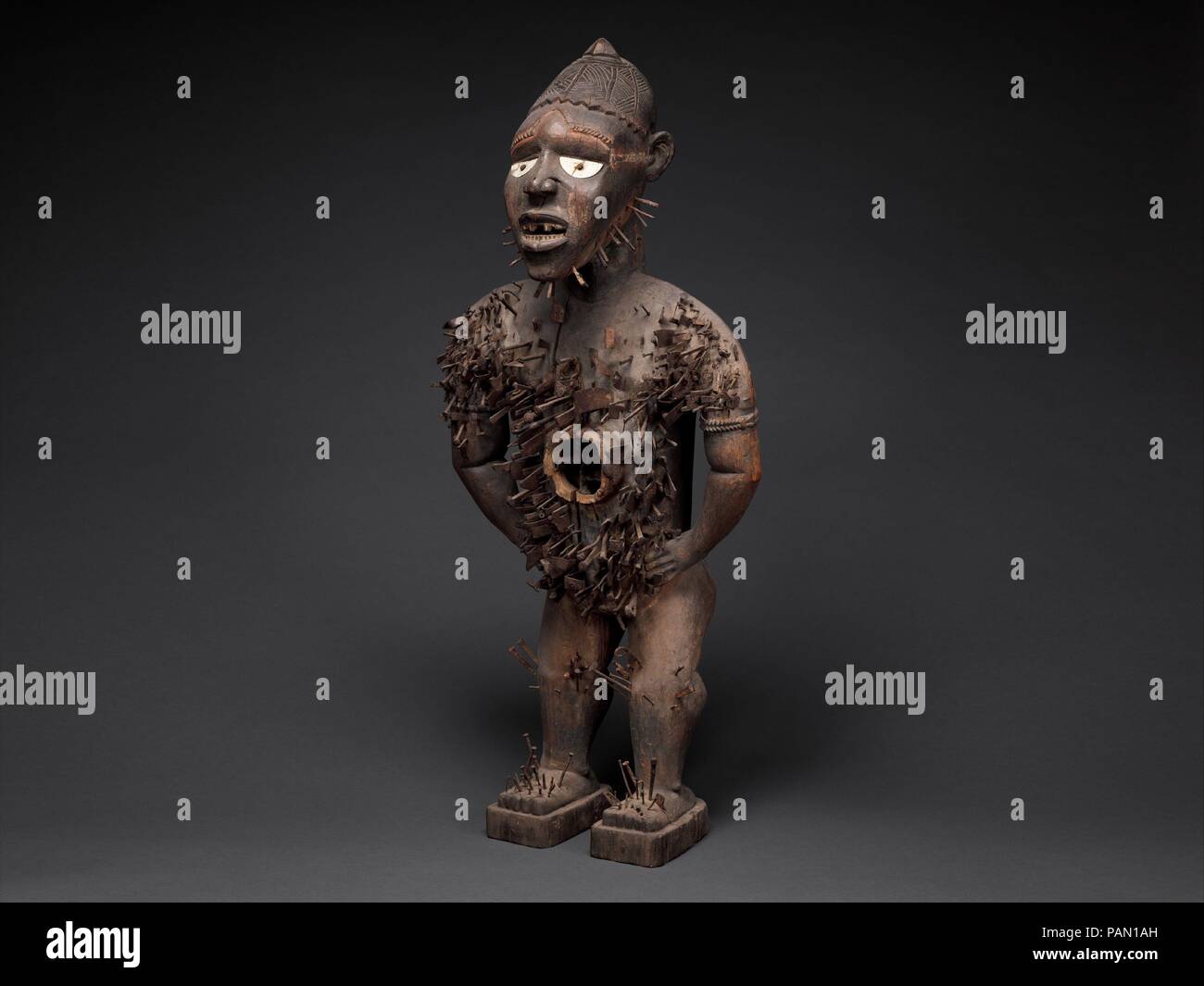 Power Figure (Nkisi N'Kondi: Mangaaka). Culture: Kongo peoples; Yombe group. Dimensions: H. 46 1/2 in. (118 cm), W. 19 1/2 in. (49.5 cm), D. 15 1/2 in. (39.4 cm). Date: 19th century.  Central African power figures are among the ubiquitous genres identified with African art. Conceived to house specific mystical forces, they were collaborative creations of Kongo sculptors and ritual specialists. This example belongs to the most ambitious class of that tradition, attributed to the atelier of a master active along the coast of Congo and Angola at the end of the nineteenth century and identified wi Stock Photo