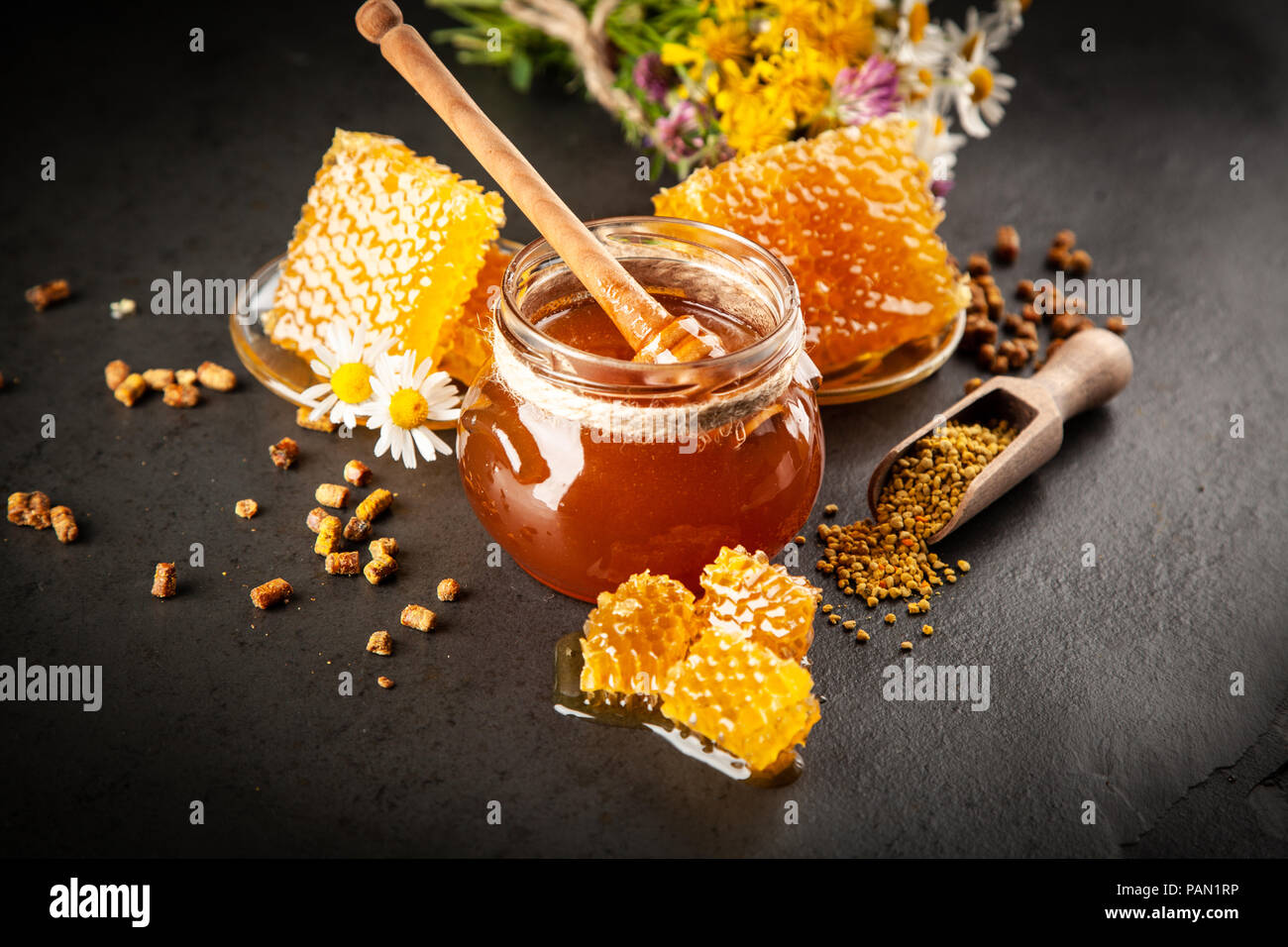 Honey jar and dipper with leaking honey Stock Photo Alamy