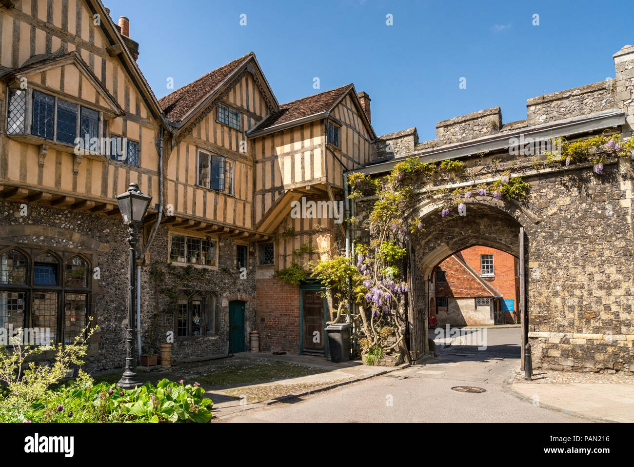 Priory Gate and tudor buildings of Cheyney Court with St Swithun upon Kingsgate beyond part of Winchester cathedral, Hampshire, England. Stock Photo