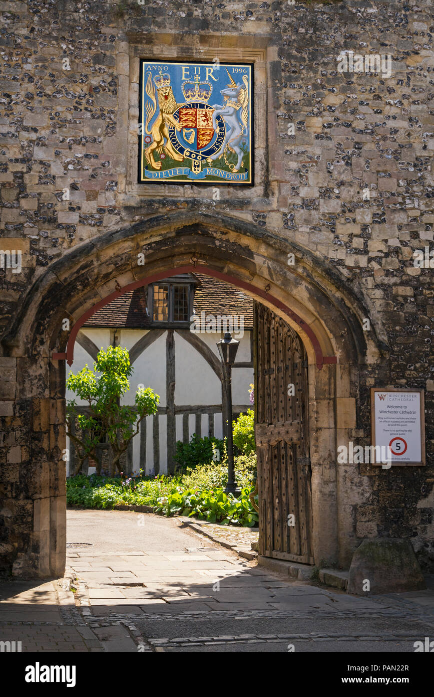 Priory Gate and part of Cheyney Court by Winchester cathedral, Hampshire, England. Coat of Arms for Queen Elizabeth II above. Stock Photo