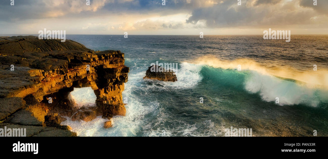 Unnamed sea arch and waves in the Puna district, Hawaii. Stock Photo