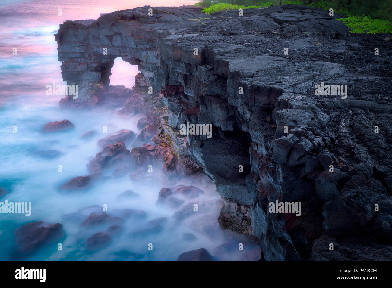 Unnamed sea arch in the Puna district, Hawaii. Stock Photo
