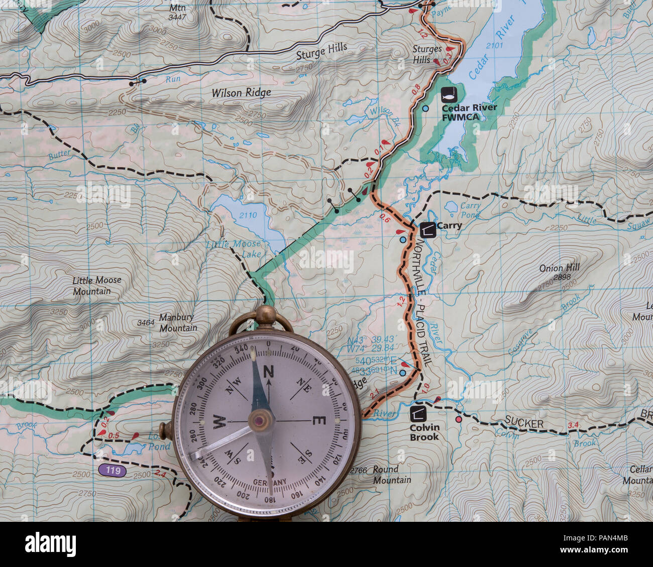 A topographic map of a portion of the Adirondack Mountains with a compass to assist in navigation. Stock Photo