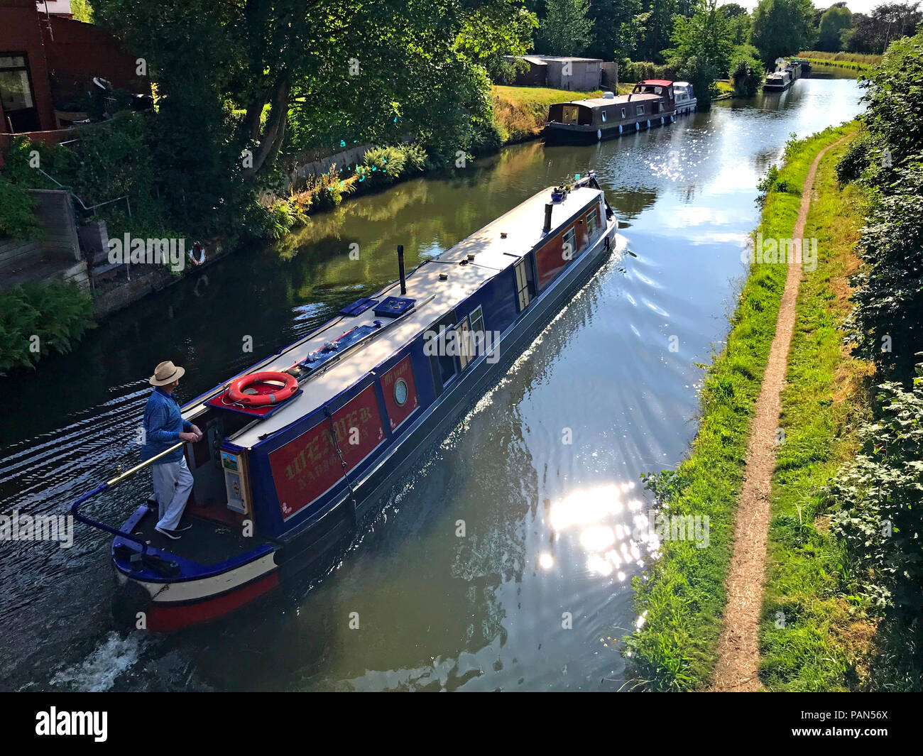Canal boat sailing westwards at Grappenhall, South Warrington, Cheshire, North West England, UK, WA4 2SJ Stock Photo