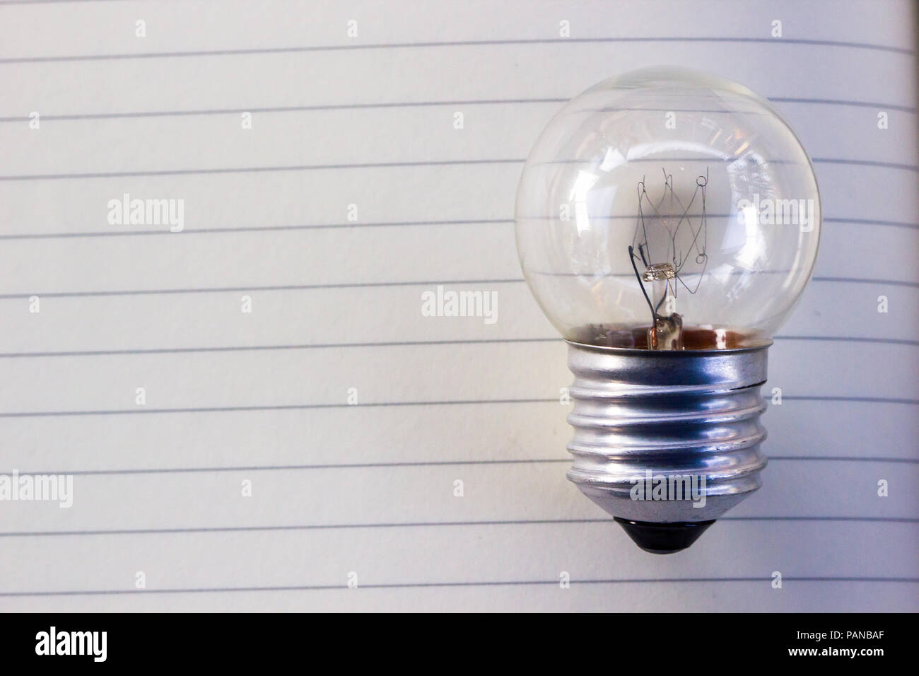 Creative thinking concept : Light bulb on empty notebook with copy space for text. Stock Photo