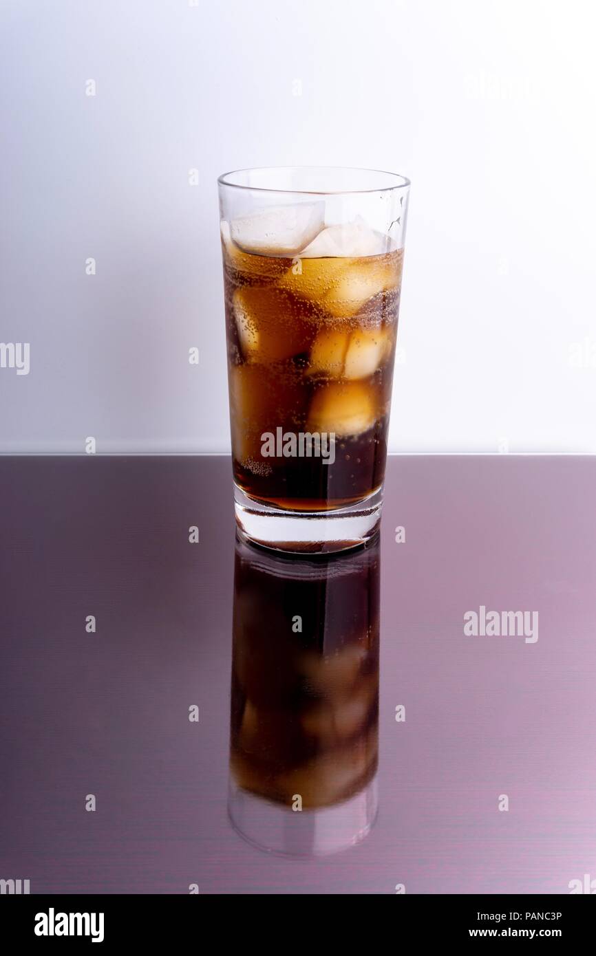 Cola in glass with ice cubes on white background Stock Photo - Alamy