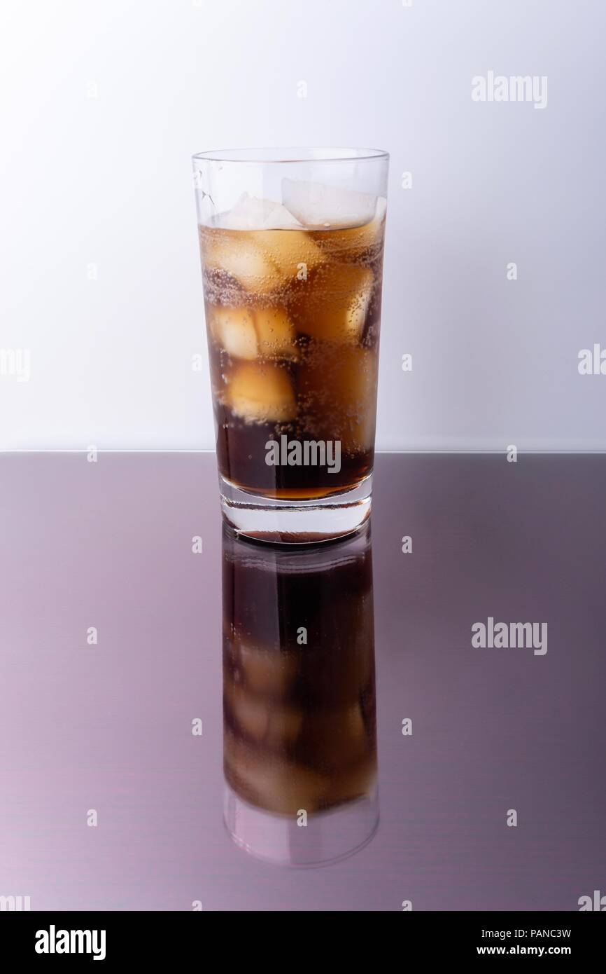 Cola in glass with ice cubes on white background Stock Photo - Alamy