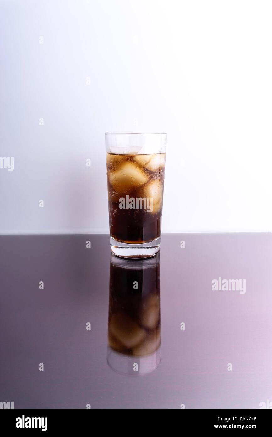 Cola in glass with ice cubes on white background Stock Photo - Alamy