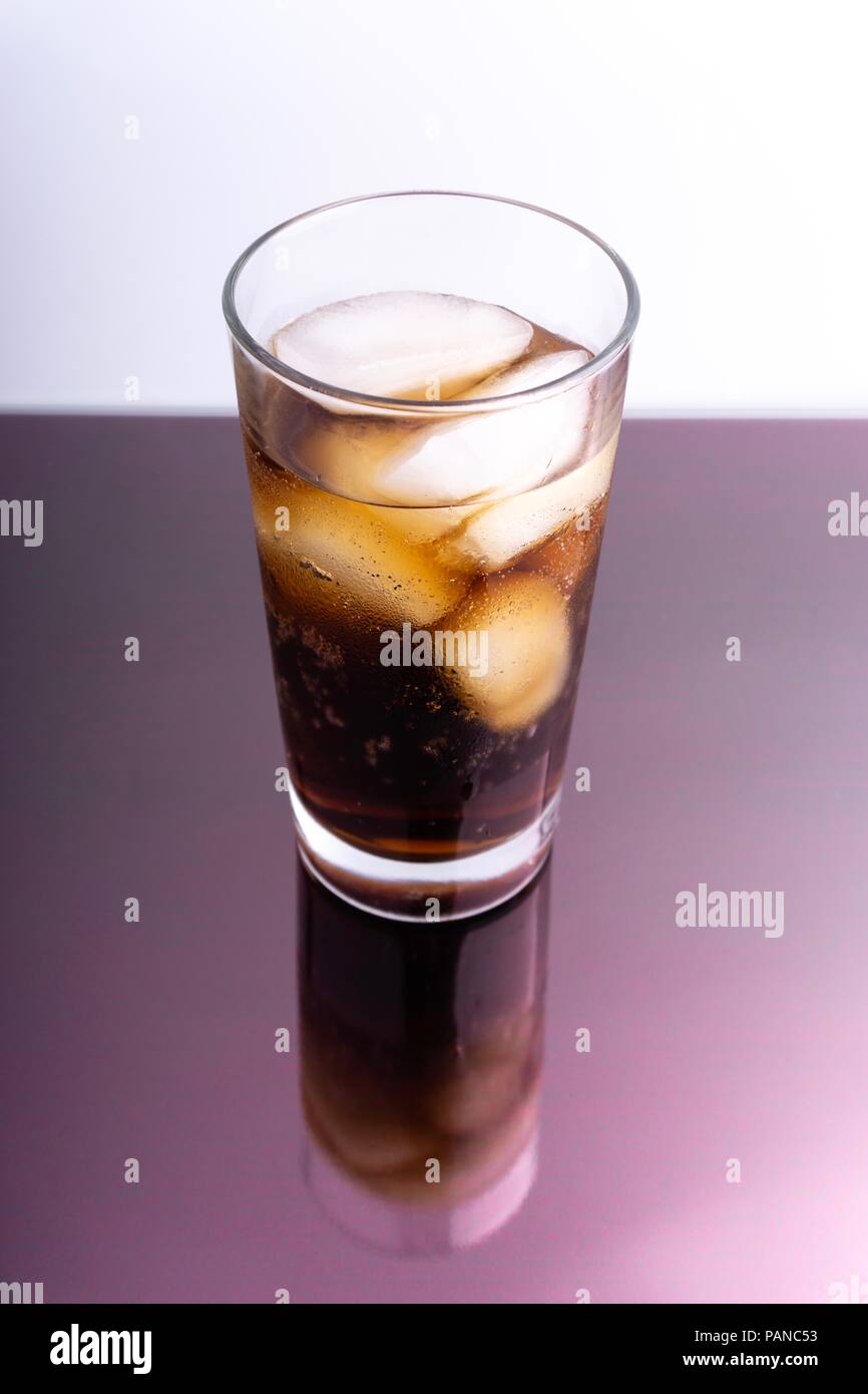 Cola in glass with ice cubes on white background Stock Photo - Alamy